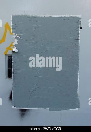 Torn street poster with gray paint abstract blank background. Design element with copy space. Stock Photo