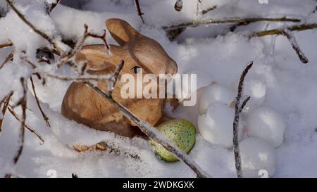 An easter bunny in the snow. Egg shells. Stock Photo