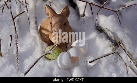 An easter bunny in the snow. Egg shells. Stock Photo