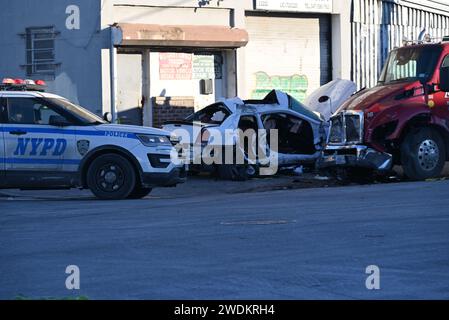 Bronx, New York, USA. 21st Jan, 2024. Police vehicles block the road and officers investigate as car parts are scattered following the vehicle crash. Fatal vehicle collision in Bronx. At approximately 3:18 am, Sunday morning at Bryant Avenue and Viele Avenue, a 24-year-old male operating a white Chrysler failed to properly navigate the roadway and struck another vehicle. Credit: SOPA Images Limited/Alamy Live News Stock Photo