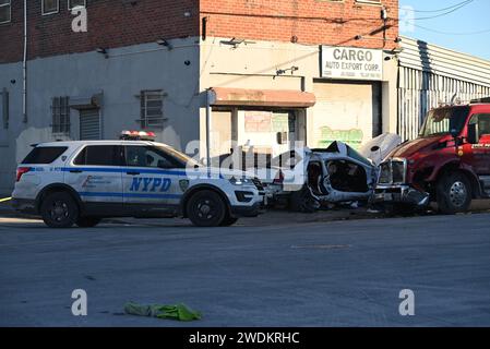 Bronx, New York, USA. 21st Jan, 2024. Police vehicles block the road and officers investigate as car parts are scattered following the vehicle crash. Fatal vehicle collision in Bronx. At approximately 3:18 am, Sunday morning at Bryant Avenue and Viele Avenue, a 24-year-old male operating a white Chrysler failed to properly navigate the roadway and struck another vehicle. Credit: SOPA Images Limited/Alamy Live News Stock Photo