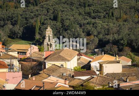 Beautiful view of village in Corfu Greece. village in mountains covered with forest. A traditional village with red clay rooftops. Stock Photo