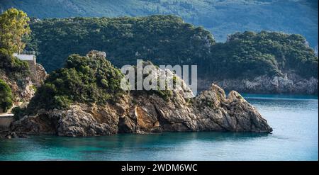 panoramic view of Rocky coastline covered by trees. Rocky coastline in amazing blue Ionian Sea in Corfu island in Greece. Stock Photo