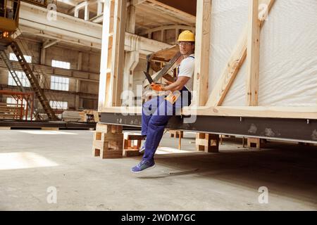 Handsome man builder using modern laptop at work Stock Photo