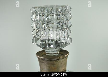 Cubic cut glass stopper from a carved and silver decanter Stock Photo