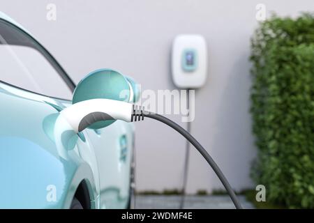 Charging an electric vehicle at home with a wallbox. Focus on the plug in the car. Selective focus. Stock Photo