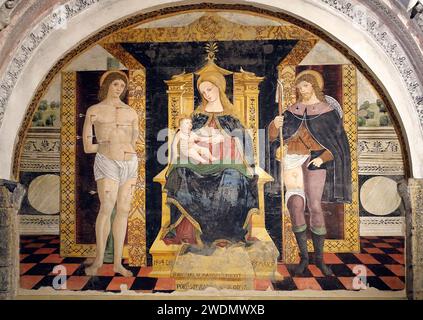 Italy Lombardy Como Lake - Como Basilica of San Fedele, Giovanni Andrea De Magistris, Madonna enthroned with child between Saints Sebastian and Rocco (1504) Stock Photo