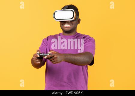 Portrait of black man wearing VR glasses using remote controller Stock Photo