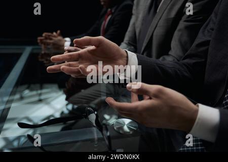 Business partners discuss financial reports, plan an investment strategy. Team of three Stock Photo