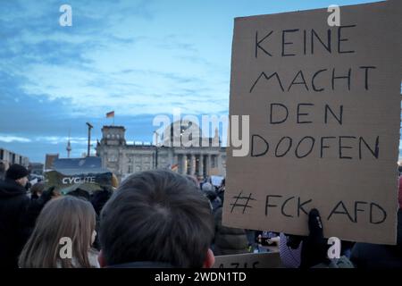 Berlin, Germany - January 21, 2024: Protestor is holding 'keine Macht den Doofen' (german: 'no power to the stupid') sign at protest at Reichtag Stock Photo