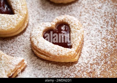 Heart shaped Linzer Christmas cookies filled with strawberry marmalade, dusted with sugar Stock Photo
