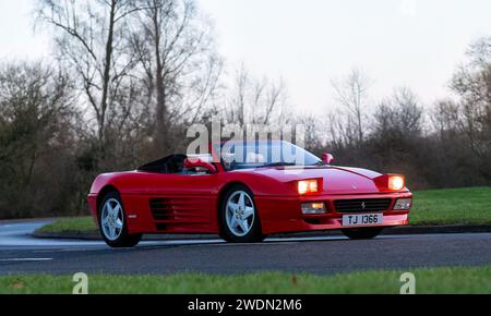 Stony Stratford,UK Jan 1st 2024. 1994 red Ferrari 348 sports car with pop up headlights arriving at Stony Stratford for the annual New Years Day event Stock Photo