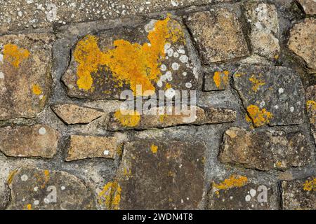 A close up shot of a crazy paving style stone wall shot in landscape format for use as a background or cover. Stock Photo