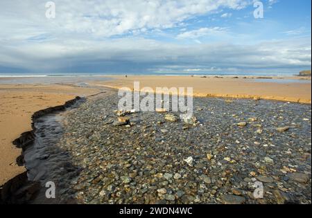 Watergate Bay, Cornwall, England, November 2023, A beach scene showing a river on the sand Stock Photo
