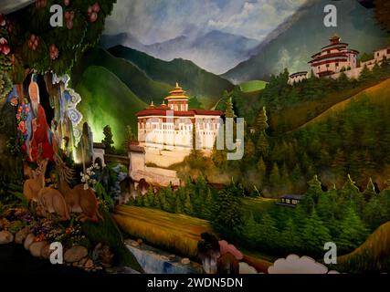 Paintings of rural scenes and the iconic Paro Dzong (fort) as a Welcome to the Kingdom of Bhutan display in the arrivals hall at Paro Airport, Bhutan Stock Photo