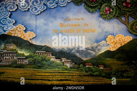 Paintings of rural scenes and the iconic Paro Dzong (fort) as a Welcome to the Kingdom of Bhutan display in the arrivals hall at Paro Airport, Bhutan Stock Photo