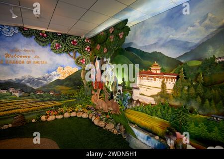 Paintings of rural scenes and the iconic Paro Dzong (fort) as a Welcome to the Kingdom of Bhutan display in the arrivals hall at Paro Airport, Bhutan Stock Photo