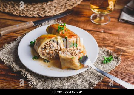 Sliced Cabbage Rolls Stuffed with Minced Beef and Rice on White Plate Served with Chopped Parsley Stock Photo