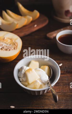 Dessert of Ice Cream Mixed with Slices of Honeydew Melon in Bowl Stock Photo