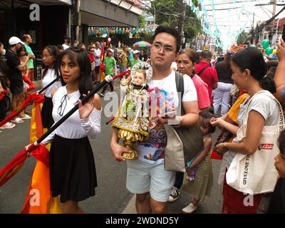 Malabon, Philippines. 21st Jan, 2024. A devotee carries his Sto. Niño replica during the parade. The Feast Sto. Niño or the holy child Jesus is celebrated every third Sunday of January, The replicas are paraded all over the country. They symbolize the birth of Catholicism in the Philippines more than 500 years ago. Credit: SOPA Images Limited/Alamy Live News Stock Photo