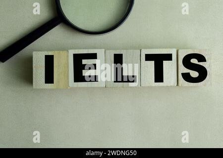 Concept of The wooden Cubes with the word IELTS on wooden background. Stock Photo