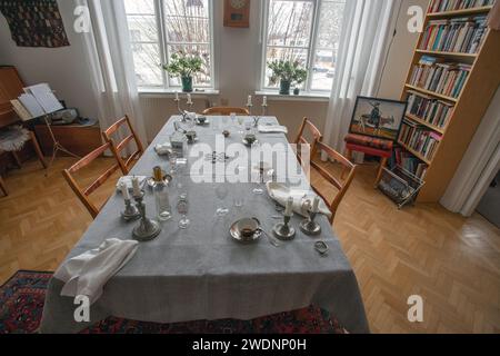 The party is over. Dinner table after party. Empty plate after dinner. Dinner set for home event. Dirty table after banquet. Celebration at home. Stock Photo