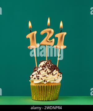 Birthday candle number 121 - Vertical anniversary card with green background Stock Photo