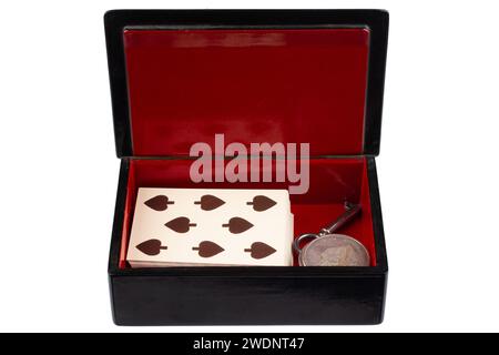 vintage old black and red casket with vintage playing cards and silver dollar coins isolated on white background Stock Photo