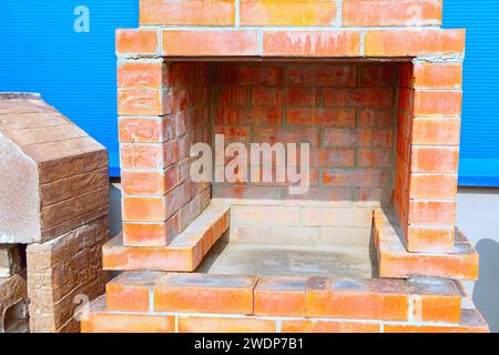 Fireplace made of bricks. Red brick oven Stock Photo