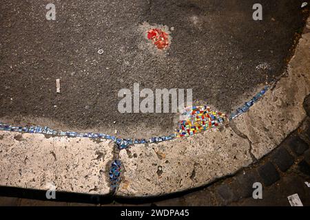 Colourful Mosaic pieces fill cracks in the sidewalk pavement – Rome, Italy – 2 November 2022 Stock Photo