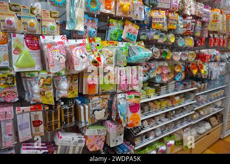 A woman wearing a facemask as a preventive measure against the spread of  Coronavirus (COVID-19) shops at Daiso 100 Yen Store in Tokyo. Daiso is one  of the biggest 100 Yen shop chains in Japan with a range of more than  100,000 items ranging from