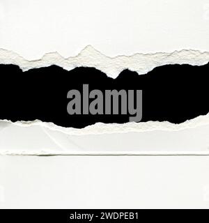 Hole ripped in white paper with black space for your message. Stock Photo
