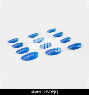 realistic set of colored false nails adhesive isolated on white background. top view. false nails acrylic nails for women. Stock Photo