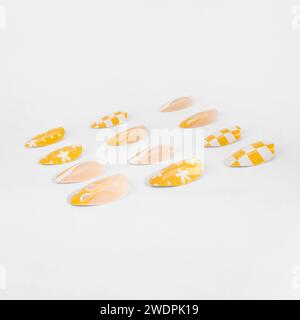 realistic set of colored false nails adhesive isolated on white background. top view. false nails acrylic nails for women. Stock Photo