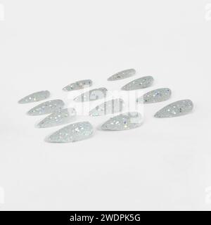 realistic set of colored false nails adhesive isolated on white background. top view. false nails acrylic nails for women. Stock Photo