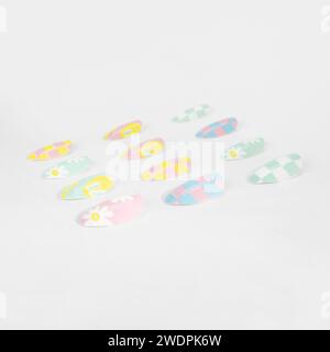 realistic set of colored false nails adhesive isolated on white background. top view. false nails acrylic nails for women. Stock Photo