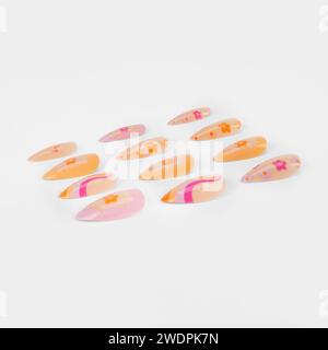 realistic set of colored false nails adhesive isolated on white background. top view. false nails acrylic nails for women. Stock Photo