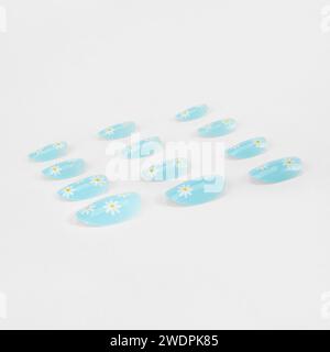 realistic set of colored false nails adhesive isolated on white background. top view. false nails acrylic nails for women. Stock Photo