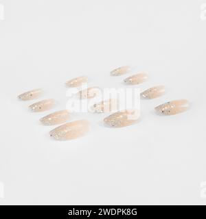 realistic set of colored false nails adhesive isolated on white background. top view. false nails acrylic nails for women. Stock Photo