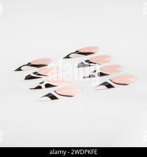 realistic set of colored false nails adhesive isolated on white background. top view. false nails acrylic nails for women. Stock Photo