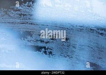Abstract frosty patterns on a frozen window, background Stock Photo