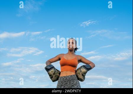 Woman seen wearing boxing gloves Stock Photo