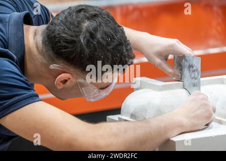 Apprentices working in various building trades including carpentry, brick laying, joinery, tiling , plastering, masonry and decorating Stock Photo