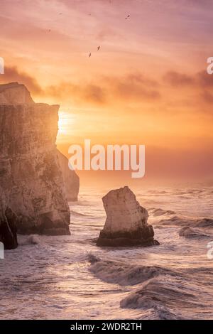 Storm Isha brewing at Seaford head on the east Sussex coast during high tide and sunrise south east England UK Stock Photo