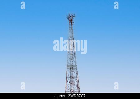 Internet signal tower or mobile phone signal tower is isolated on blue sky background texture. Global communication and internet network connection co Stock Photo
