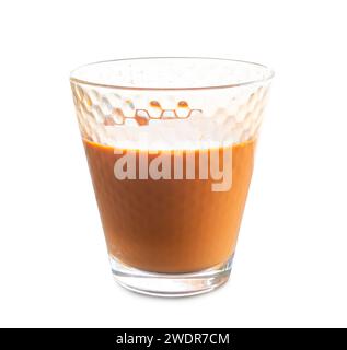 Hot orange Thai tea sweetened condensed milk in transparent glass is isolated on white background with clipping path. Stock Photo