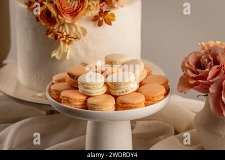 Sweet pastel colored macarons on festive table Stock Photo