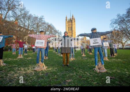 London, England, UK. 22nd Jan, 2024. GUY SINGH-WATSON, founder of Riverford Organic, poses with scarecrows outside British parliament during a protest calling for government the big six supermarkets - Tesco, Sainsbury's, Asda, Morrisons, Aldi and Lidl- to 'get fair about faming. (Credit Image: © Tayfun Salci/ZUMA Press Wire) EDITORIAL USAGE ONLY! Not for Commercial USAGE! Credit: ZUMA Press, Inc./Alamy Live News Stock Photo