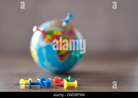 Closeup image of colorful pins on world globe. Travel destination, planning vacation concept. Stock Photo