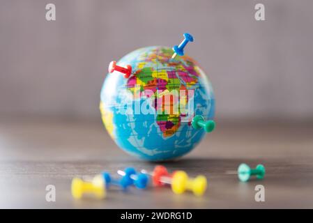 Closeup image of colorful pins on world globe. Travel destination, planning vacation concept. Stock Photo